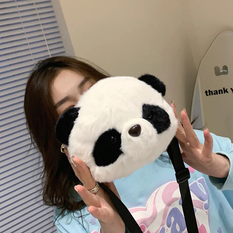 Soft plush crossbody bag with panda head design, cylindrical shape, and an outer sandwich pocket.