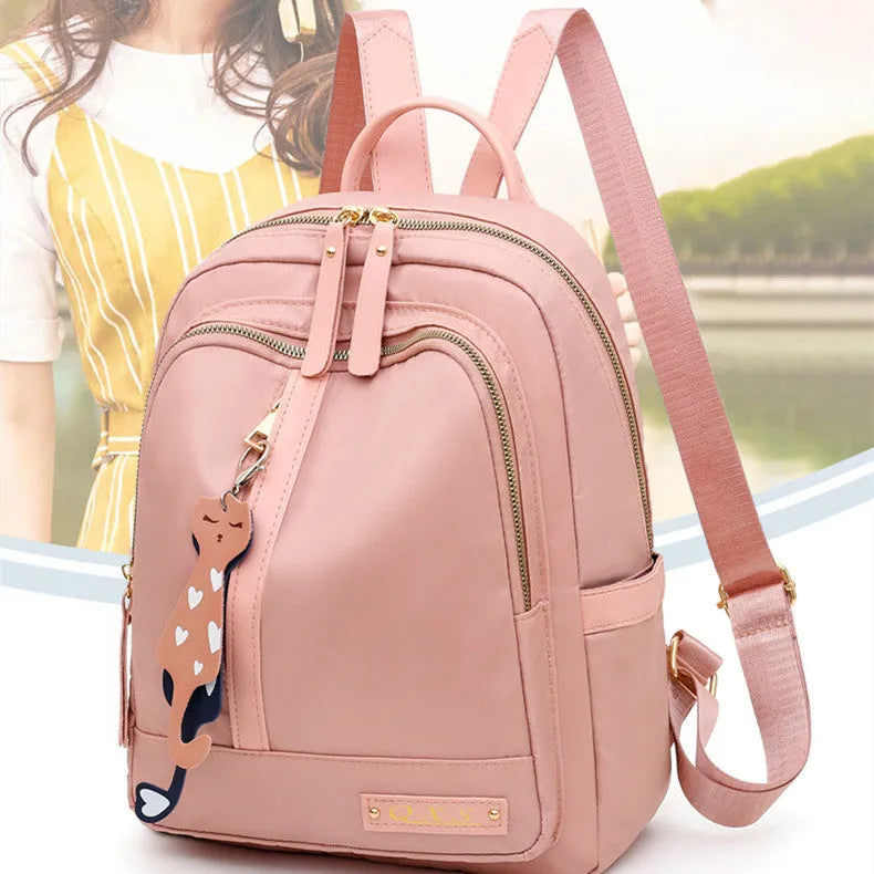 Women's casual nylon backpack in black or pink with water-resistant features and internal organisation compartments