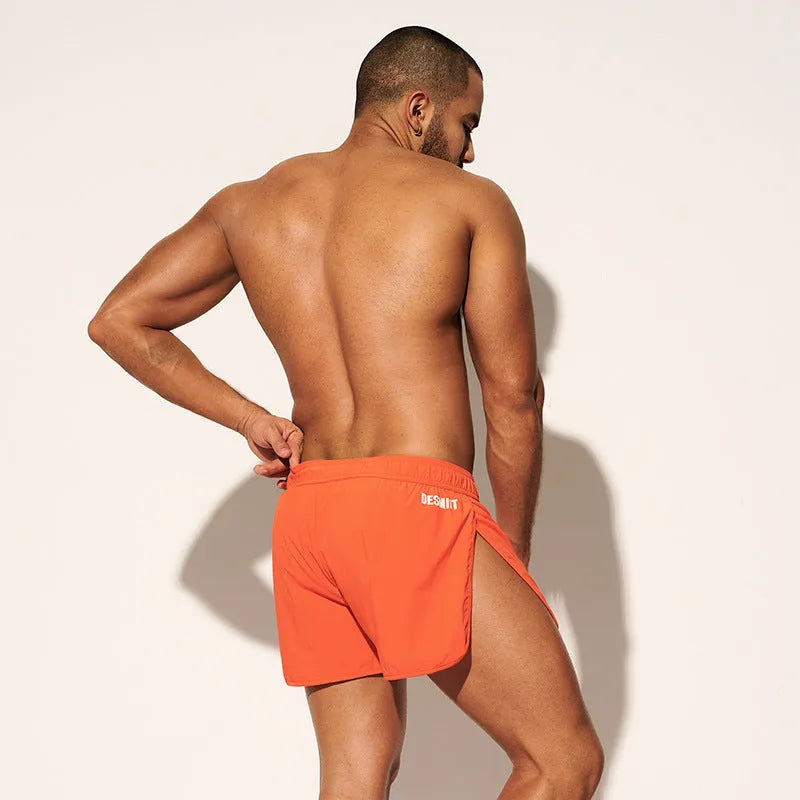Men's loose polyester beach shorts in orange red, fluorescent green, or black colours