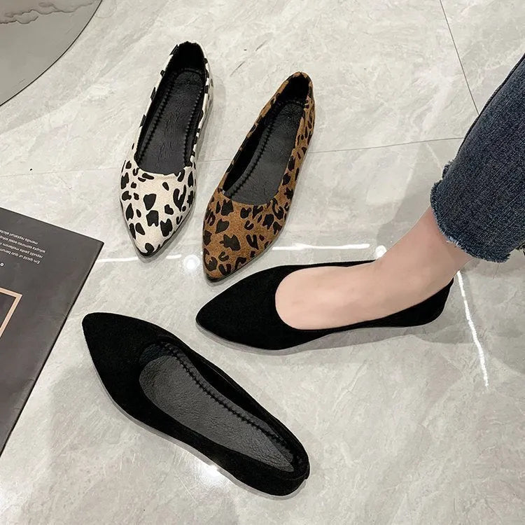 Women's leopard print flat pumps with a pointed toe and low flat heel on a rubber sole.