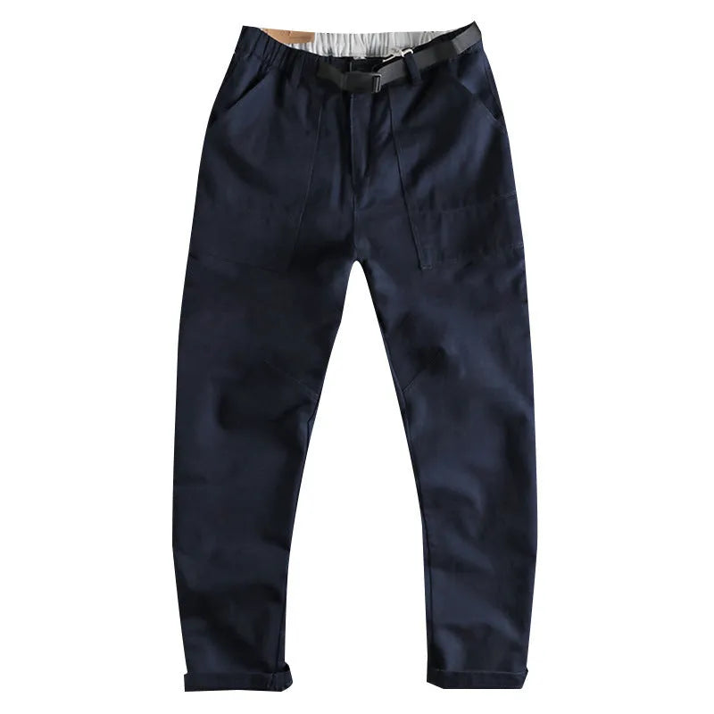 Men's khaki cotton work trousers with a flat buckle belt and zip fly, showcasing three-dimensional leg cutting.