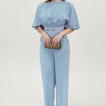 Men's blue polyester two-piece suit with long sleeve jacket and trousers on a hanger.