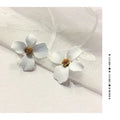 Flower shaped stud earrings in pink and white colours with electroplated alloy finish