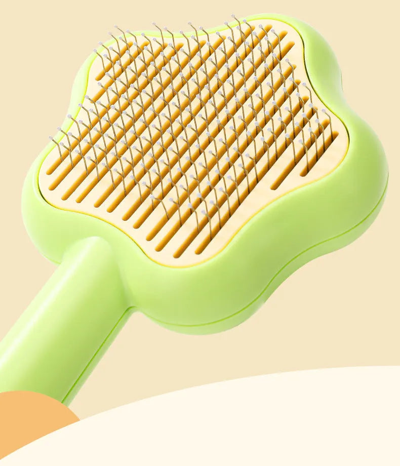 Green self-cleaning magic wand cat comb with stainless steel needle teeth on a white background.