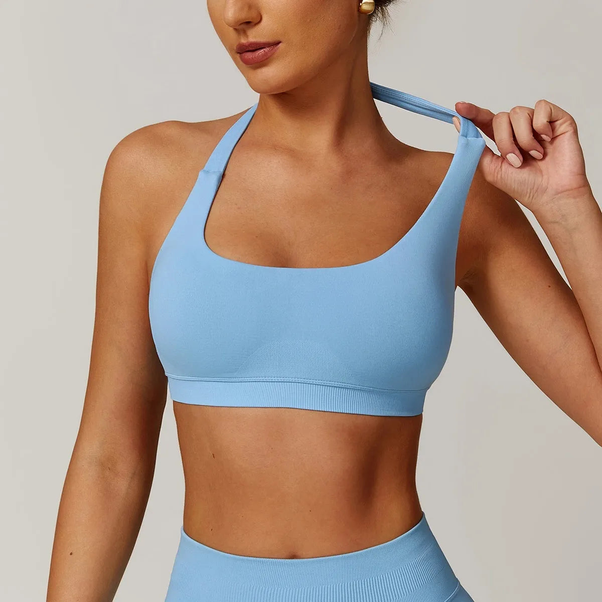 Women's halter neck yoga sports bra with removable pads in plum purple colour