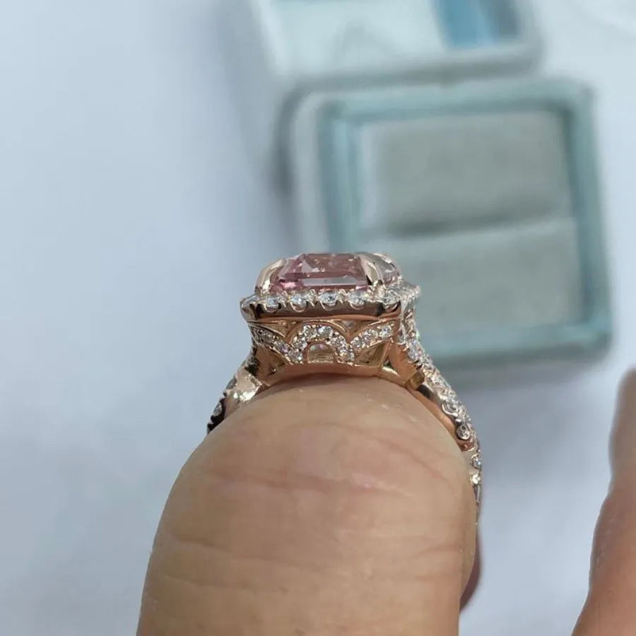 Geometric-shaped alloy ring with a rose gold electroplated finish on a neutral background.
