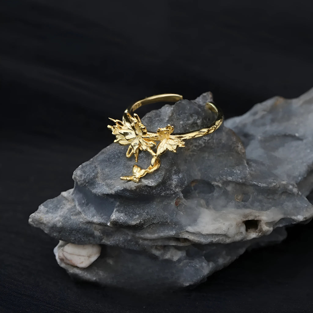 Adjustable silver butterfly ring with gold electroplating on model's finger