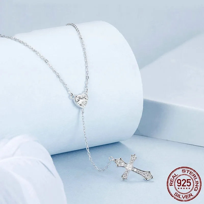 Close-up of a sterling silver V-neck cross pendant on an O-ring chain, colour BSN384.
