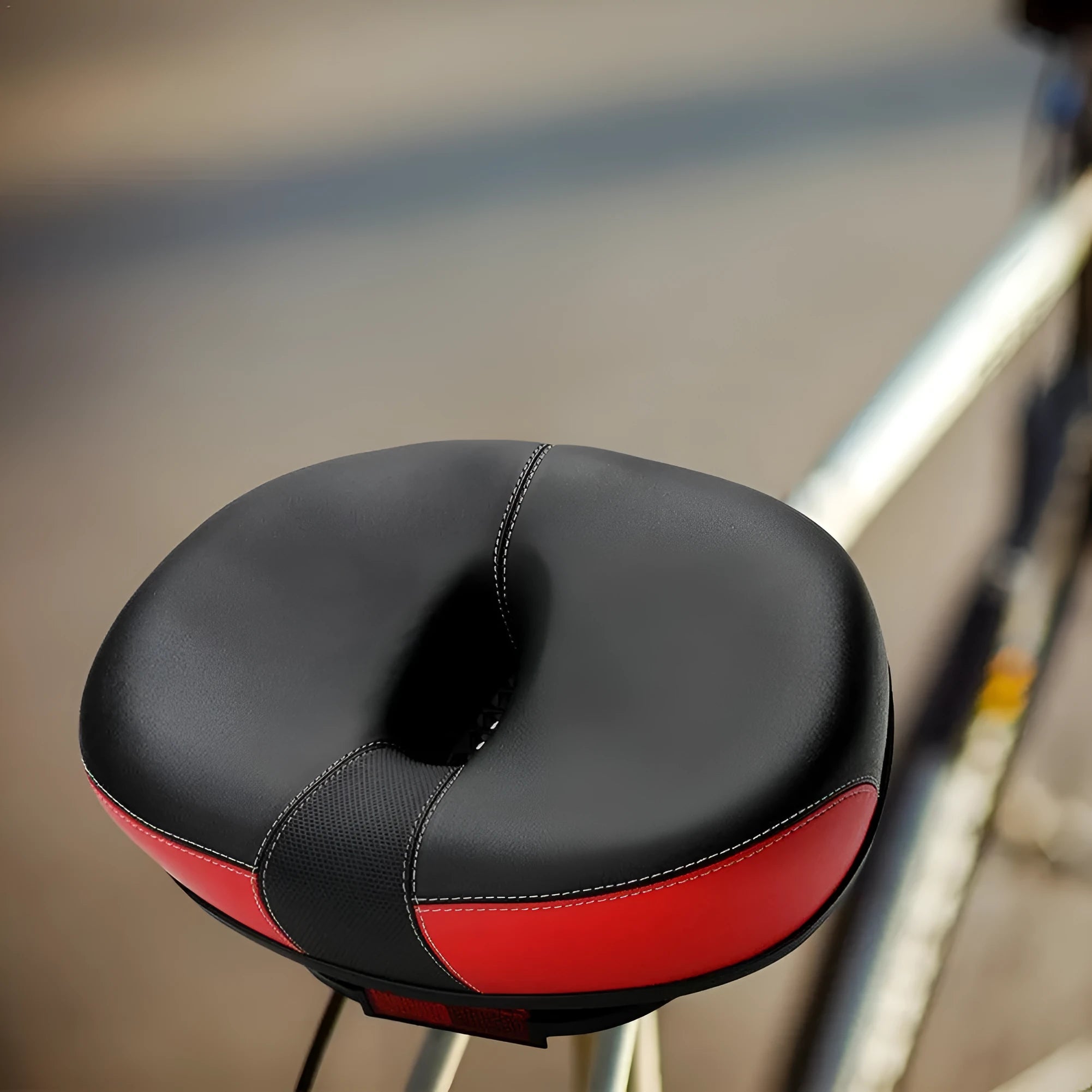 Large red bicycle saddle with reflective stickers and shock absorber for plus-size riders