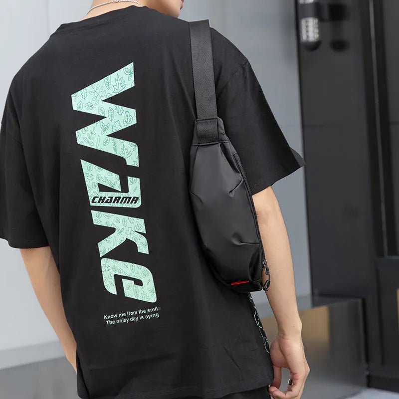Men's black Oxford cloth crossbody waist pack showing interior organisation pockets