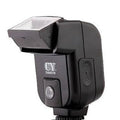 Compact silver hot shoe flash for SLR cameras with tilted head on a white background.