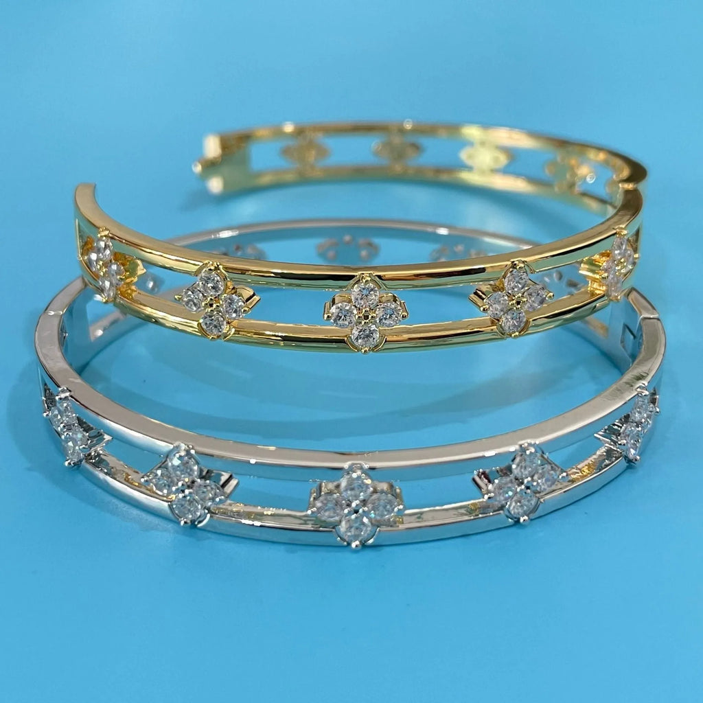 Gold and silver women's hollow bracelets with a four-leaf clover charm and zircon detailing.