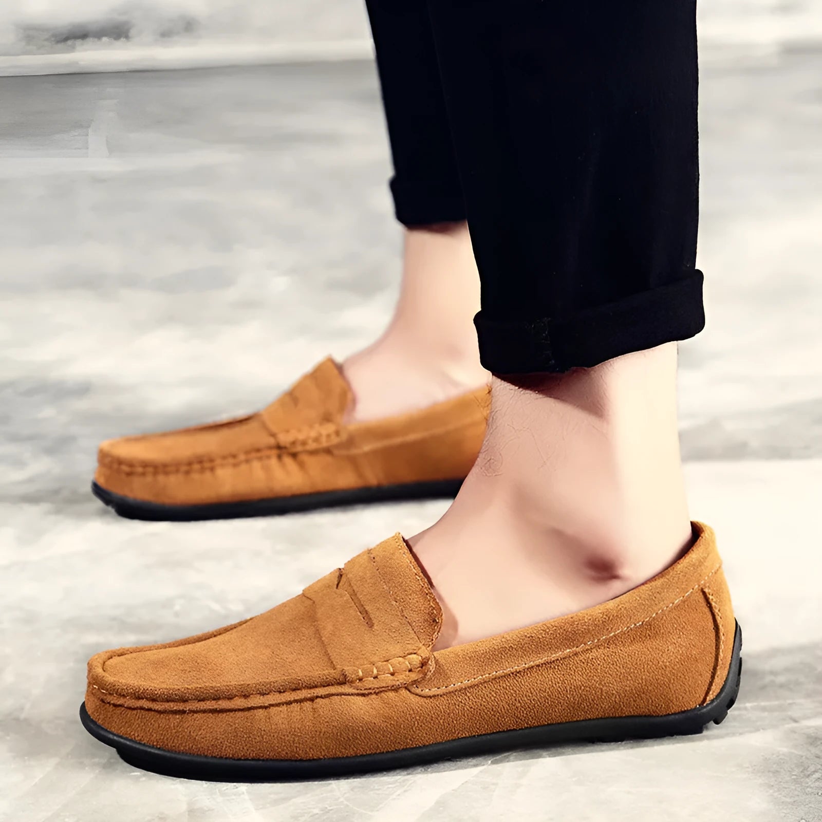 Men's brown suede casual loafers with a round toe, flat rubber sole, and visible stitching on a white background.