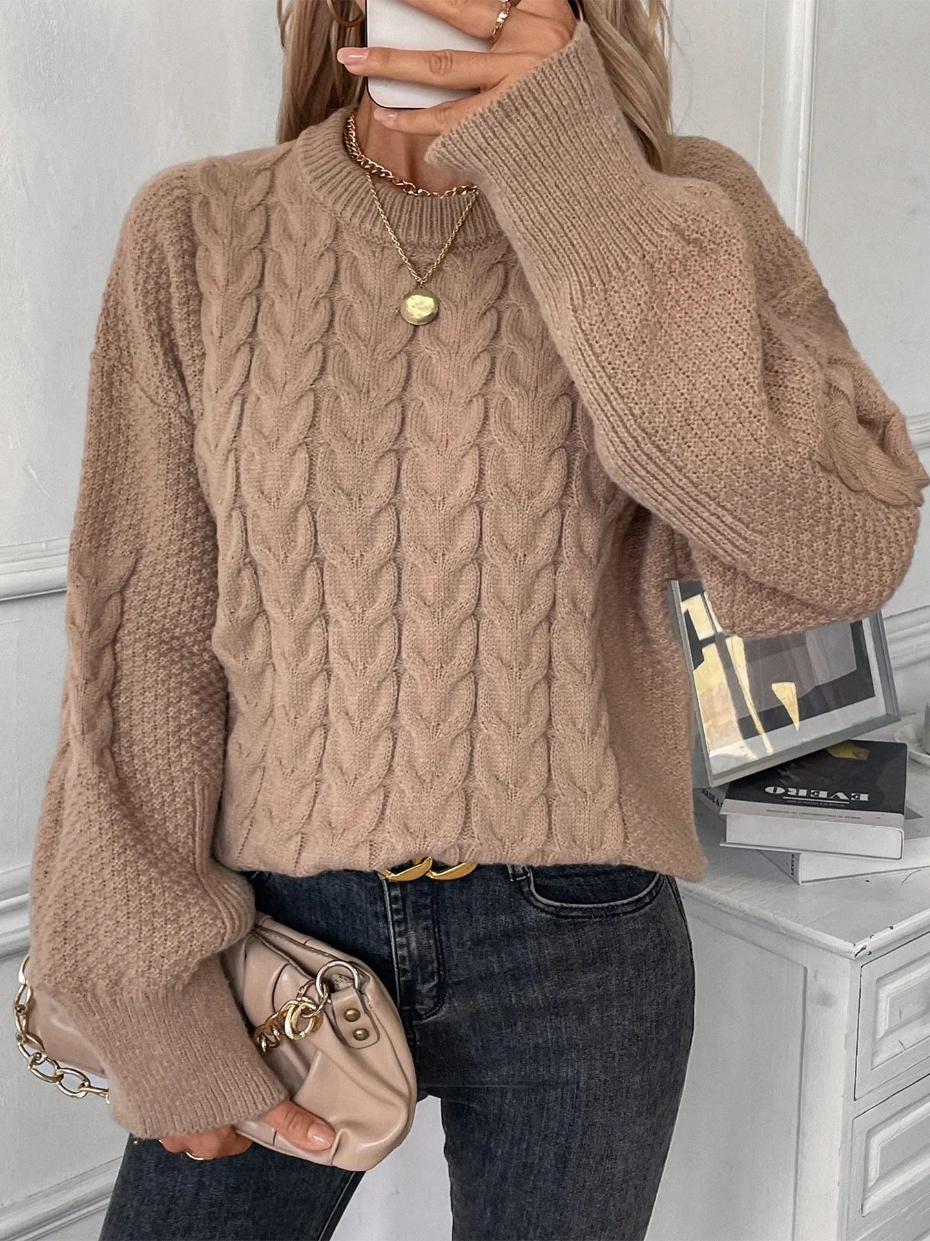 Women's beige casual sweater with twist detail and round neckline on hanger