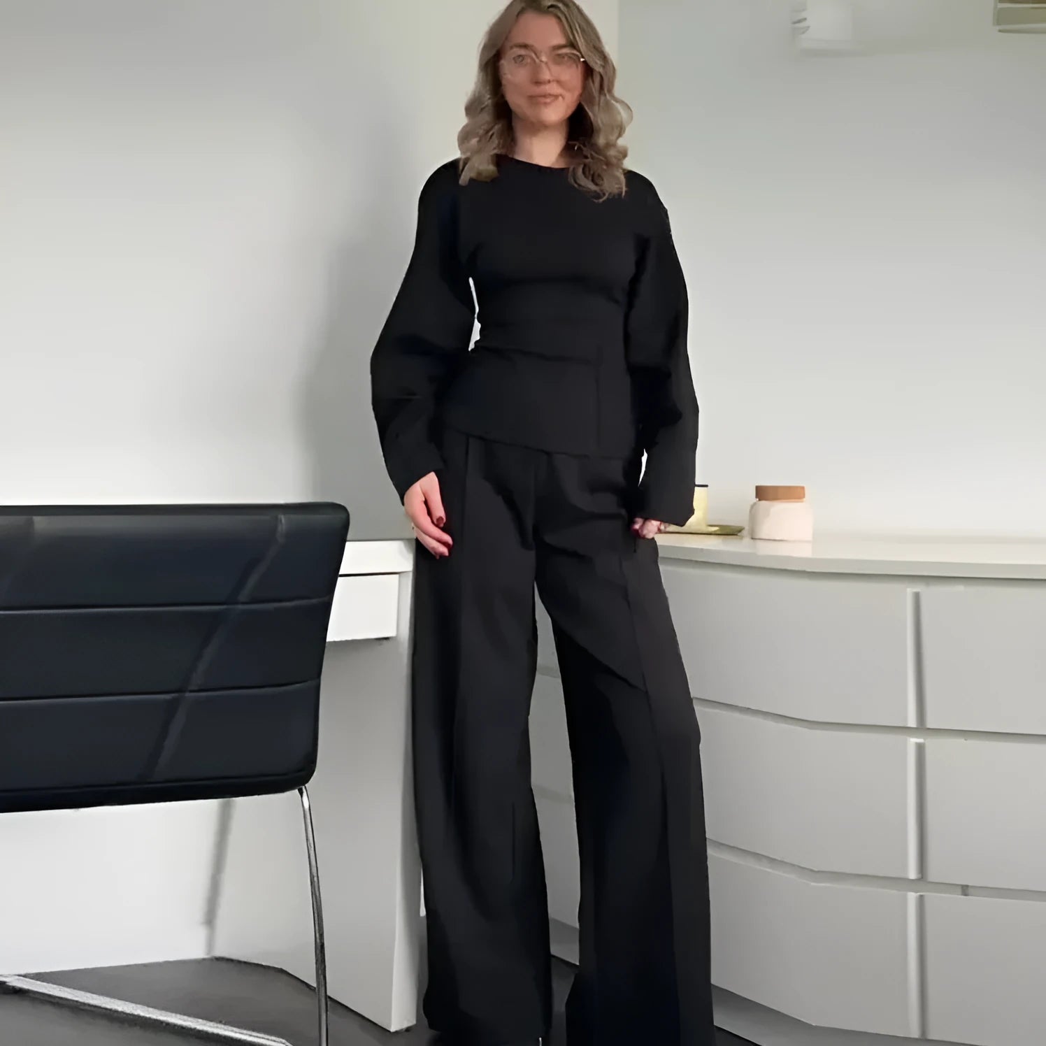 Women's black polar fleece trouser suit set with pleated long sleeve top and wide-leg pants on a hanger.