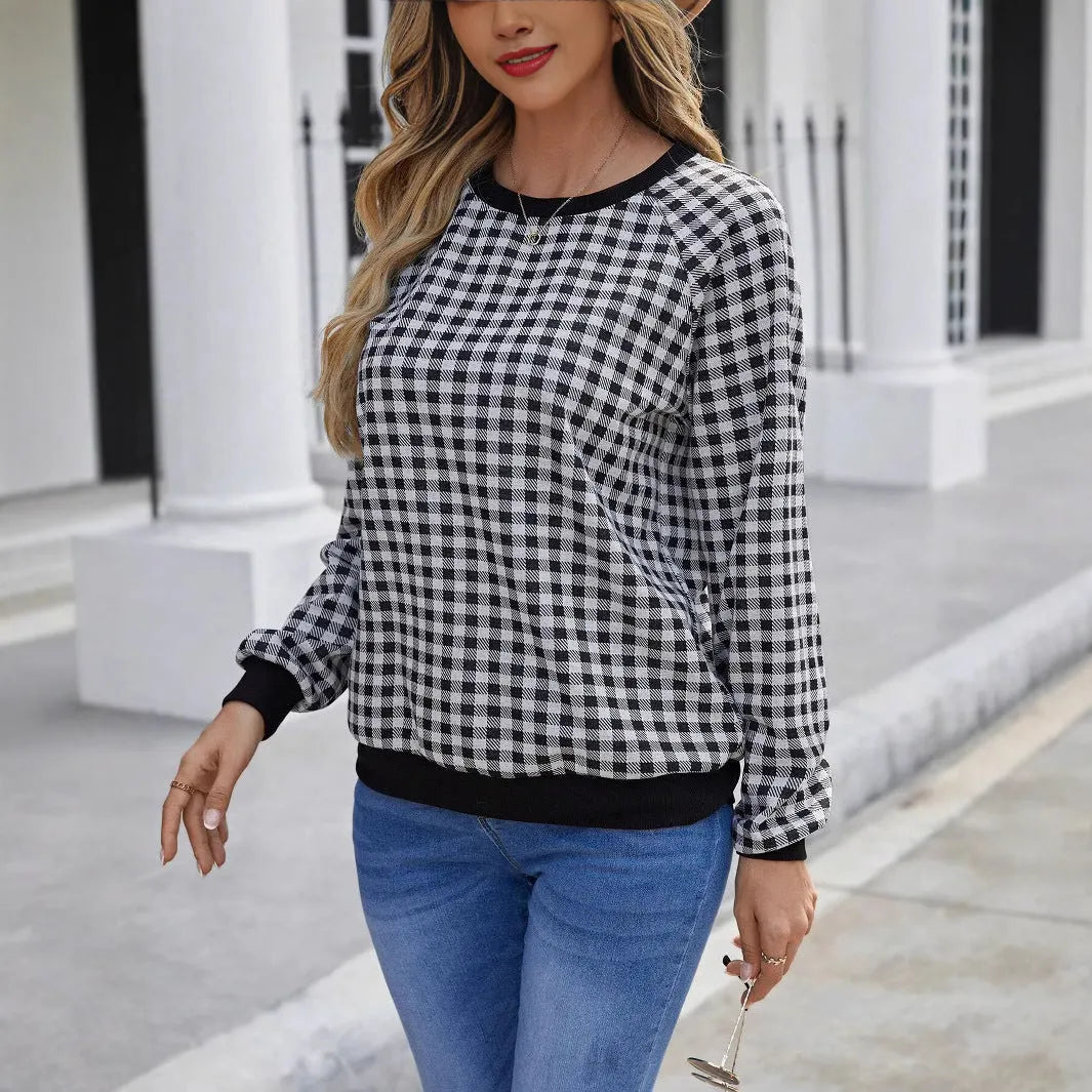 Black plaid print pullover sweater with long sleeves on mannequin