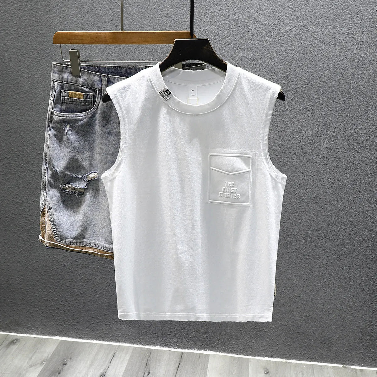 Man wearing a loose-fit black cotton sleeveless t-shirt or muscle tank.