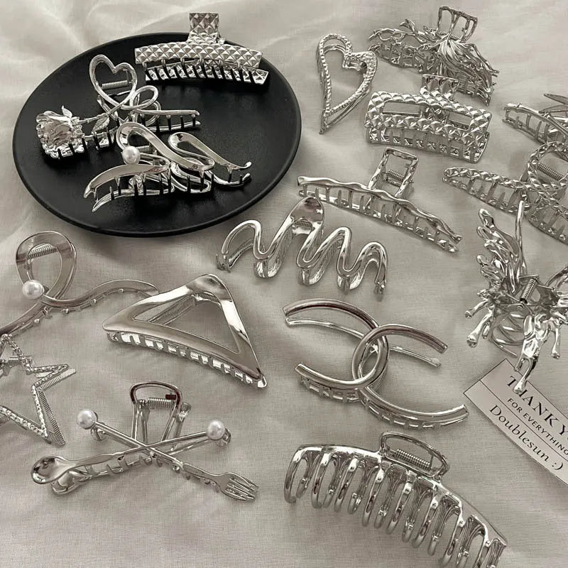 Silver electroplated metal hair claw barrette in a Korean-style design on white background