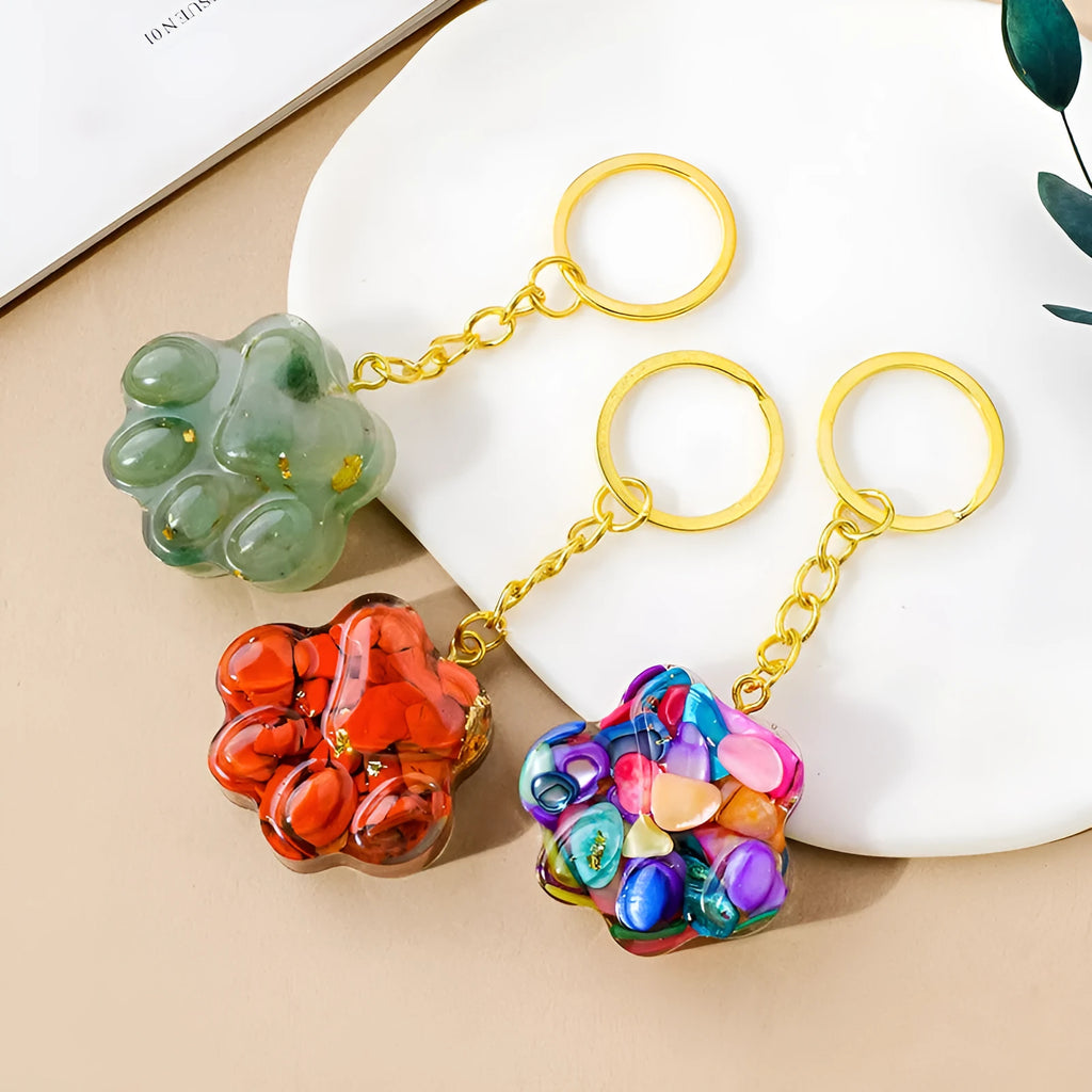 Small natural crystal cat's paw charm on a metal keyring loop.