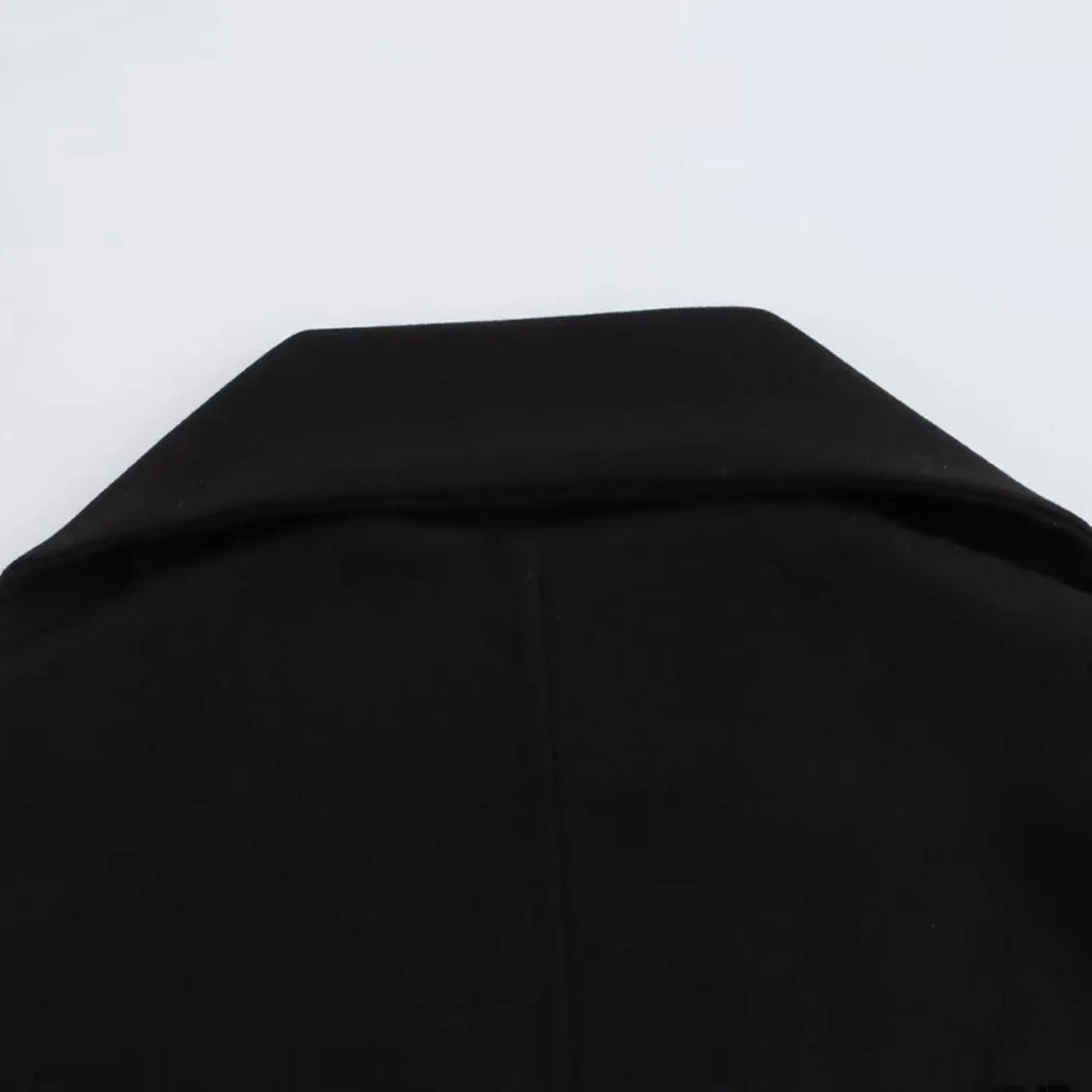 Women's long grey polyester overcoat with artificial fur collar and pockets, styled in street fashion.