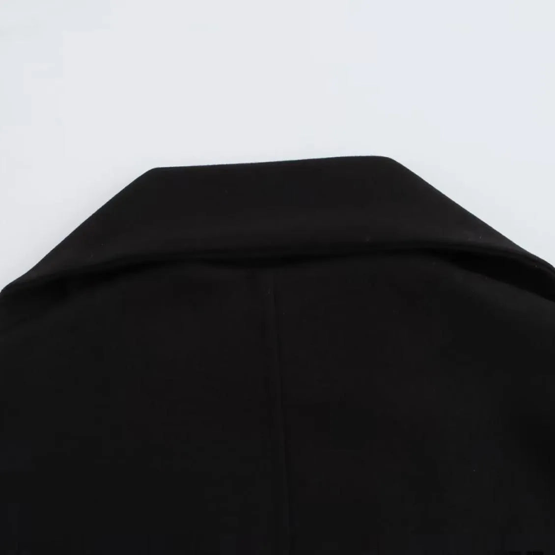 Women's long grey polyester overcoat with artificial fur collar and pockets, styled in street fashion.