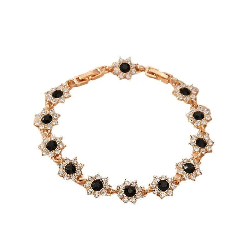 Gold and silver electroplated flower bracelets with coloured gems and crystals on a zinc alloy base.