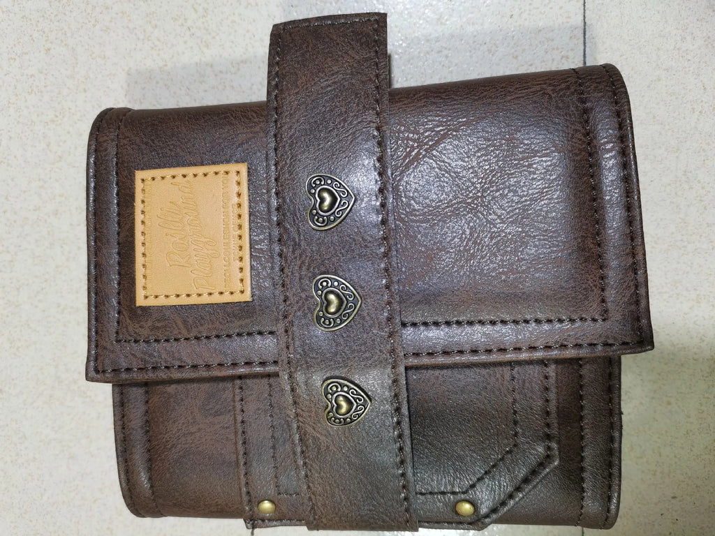 Brown retro leather-look PU cover A7 notebook with loose-leaf binder binding open on a desk.