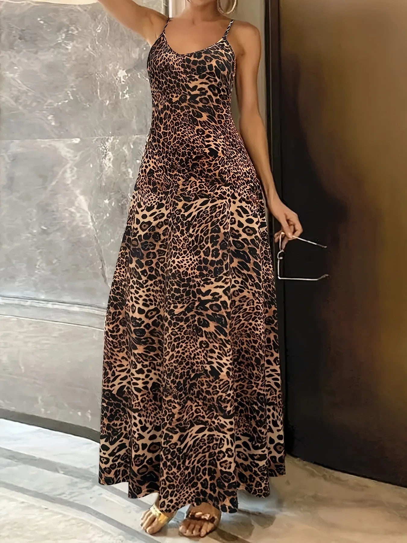 Dark brown leopard print women's long dress with sleeveless round neck and sling straps on a mannequin.