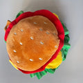 Soft fabric burger-shaped collar for cats on a neutral background, showing lettuce and cheese details.