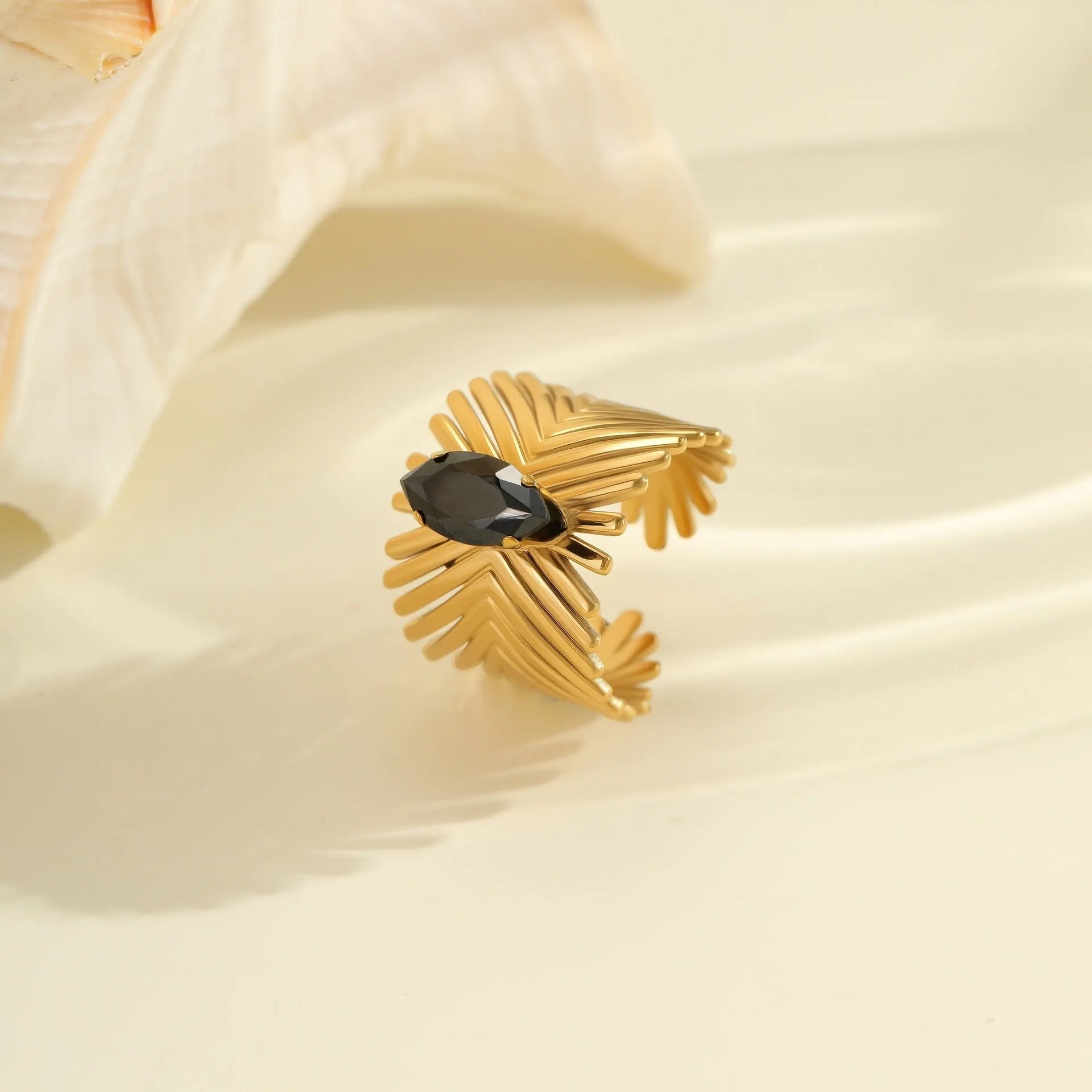 Geometric open mouth women's ring in titanium steel with inlaid zircon stones and electroplated finish.