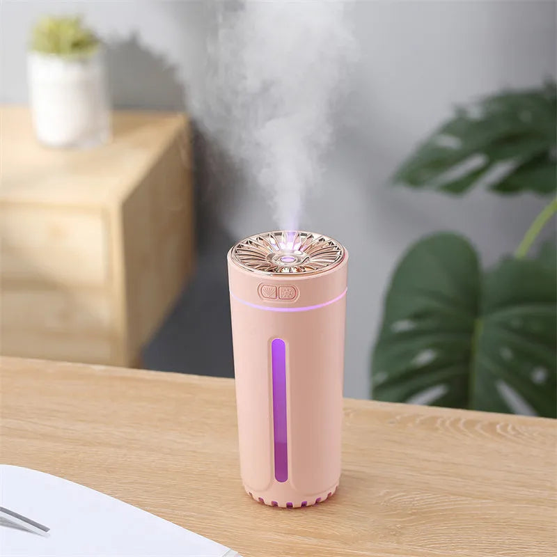 Black USB rechargeable ultrasonic humidifier with LED lights on a car cup holder
