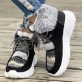 Women's beige lace-up snow boots with thermal lining and rubber sole on wooden surface