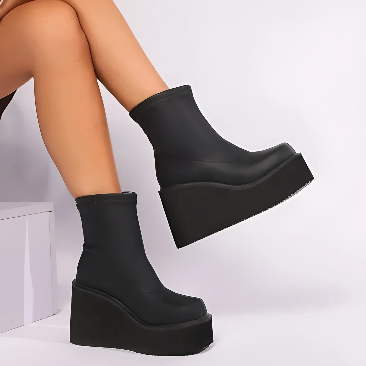 Plus size black women's wedge heel boots with a waterproof platform and round toe.
