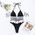 Black women's bikini swimsuit set with metal rings on the long straps, backless design.
