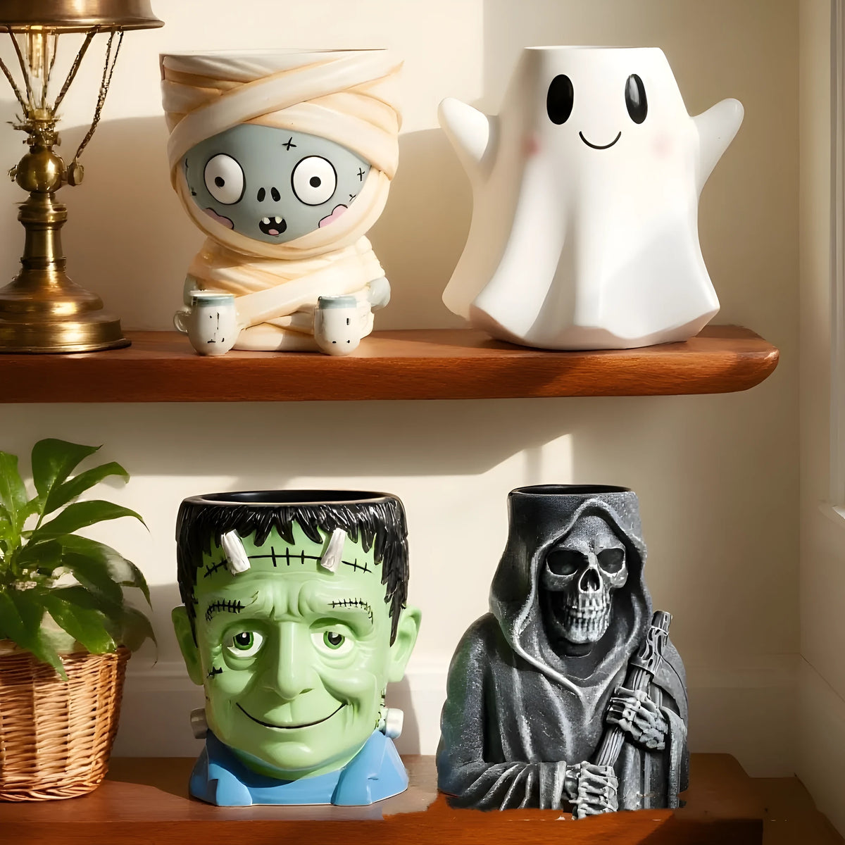 Four Halloween resin flower pot decorations showing bandage zombie, white ghost, science green freak and death designs