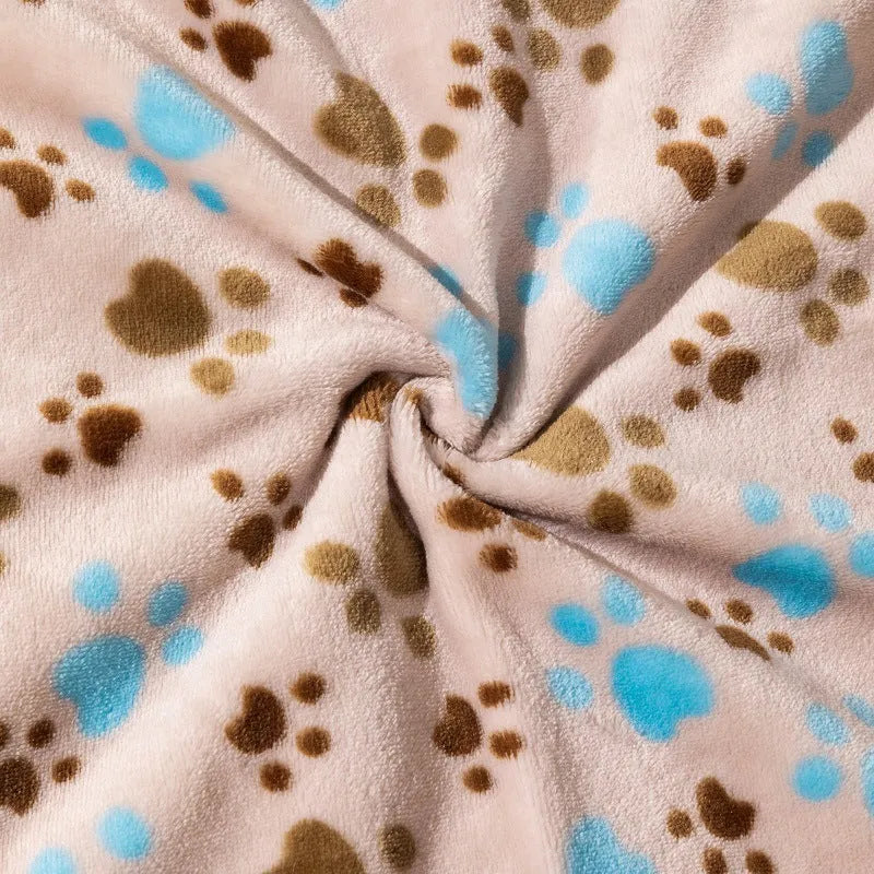 Blue cartoon dog pattern double-sided flannel pet blanket laid flat, showing its size next to a pet crate.