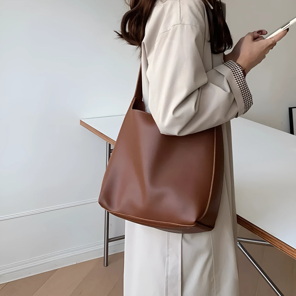 Women's soft PU leather crossbody bag with swing threads detail showing black ribbon colour option