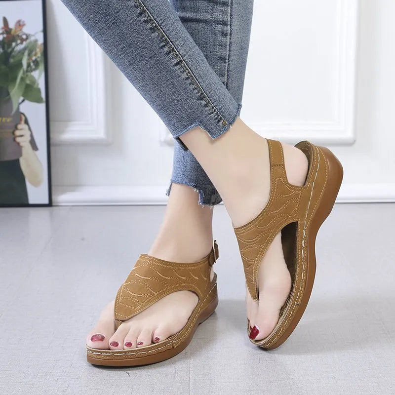 Women's casual wedge heel flip flop sandals with an adjustable buckle strap in solid colours.