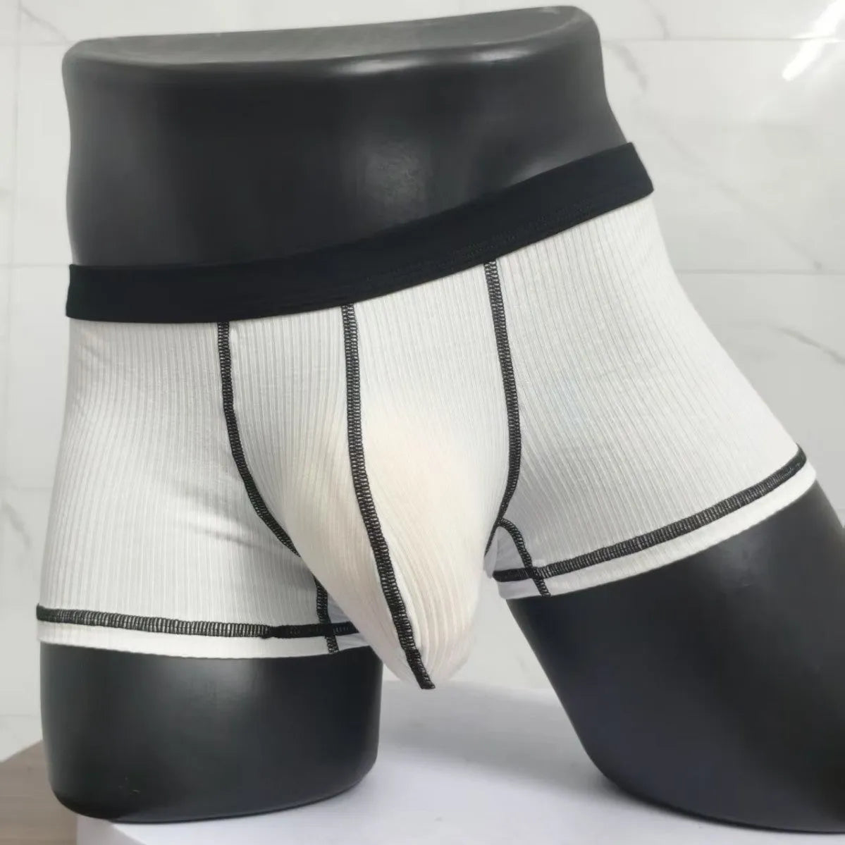 Men's solid colour boxer shorts in breathable fabric on a size chart showing L, XL, 2XL, and 3XL.