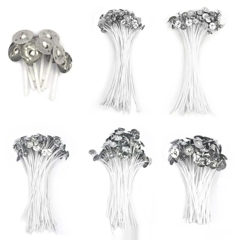 White cotton candle wicks in three lengths: 2.6cm, 6cm, and 8cm, laid out on a surface.