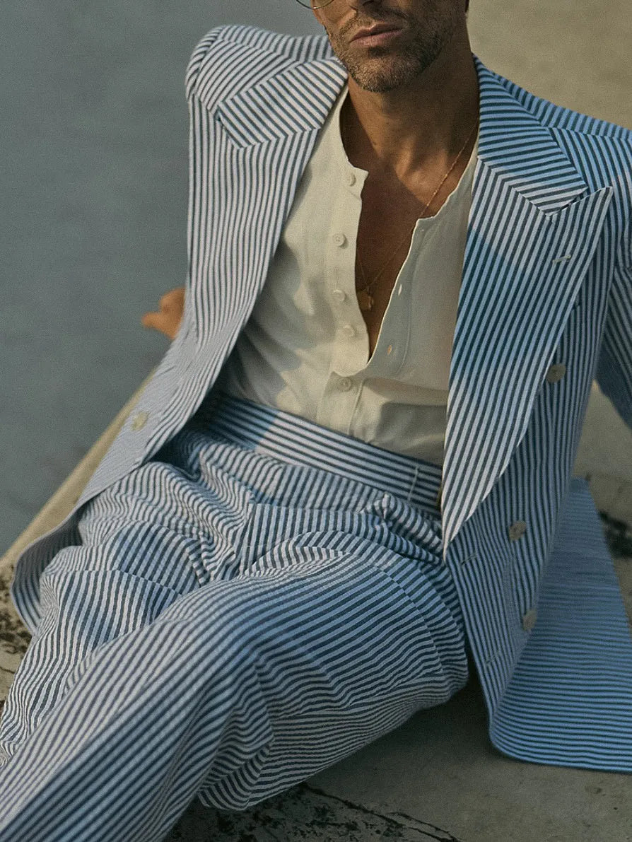 Blue and white striped polyester blazer and trousers suit set on a hanger.