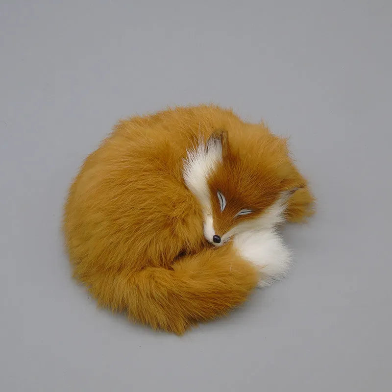 Artificial white fox fur car ornament measuring 15cm long on a car dashboard.