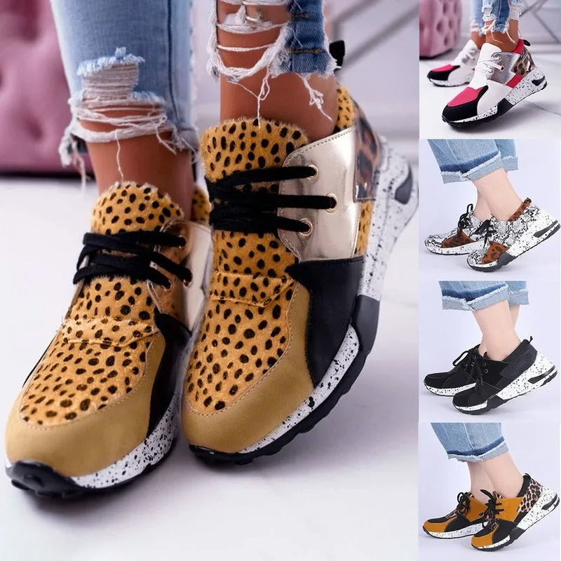 Women's black casual sneakers with a suede upper and a low wedge heel on a plastic sole.
