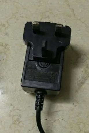 Charging hair clipper with stainless steel cutter head on a white background.
