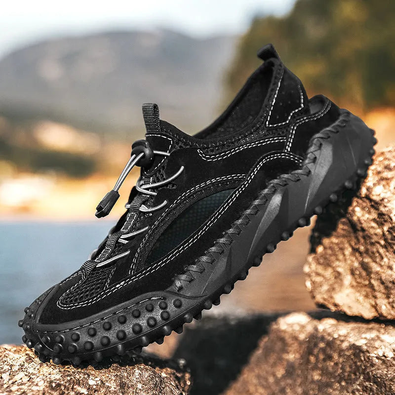 Men's black sports sandals with leather mesh upper and rubber sole showing elastic band fastening
