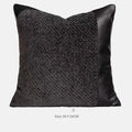 Modern grey and white plaid bed runner blanket set with leather round pillow on a bed