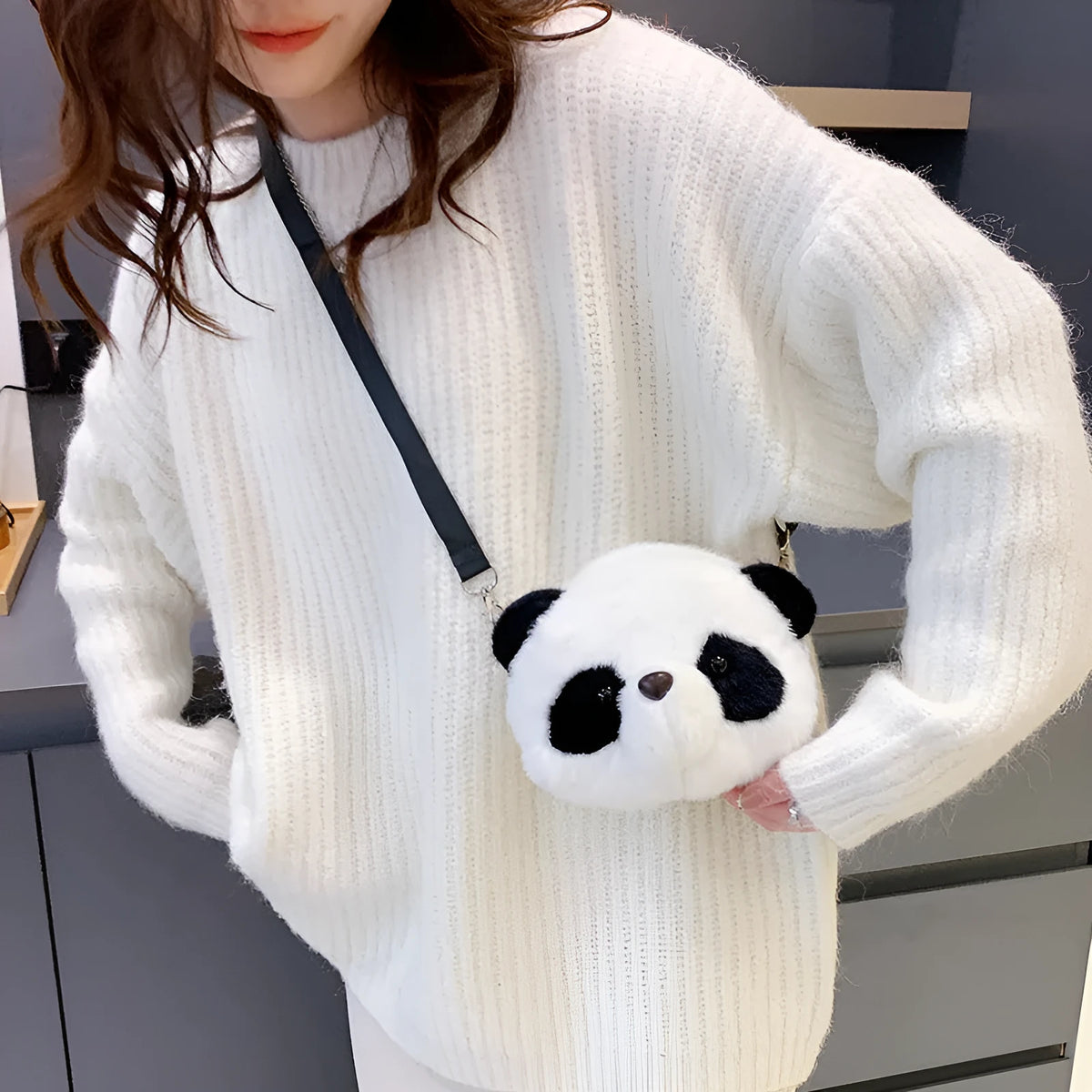 Soft plush crossbody bag with panda head design, cylindrical shape, and an outer sandwich pocket.