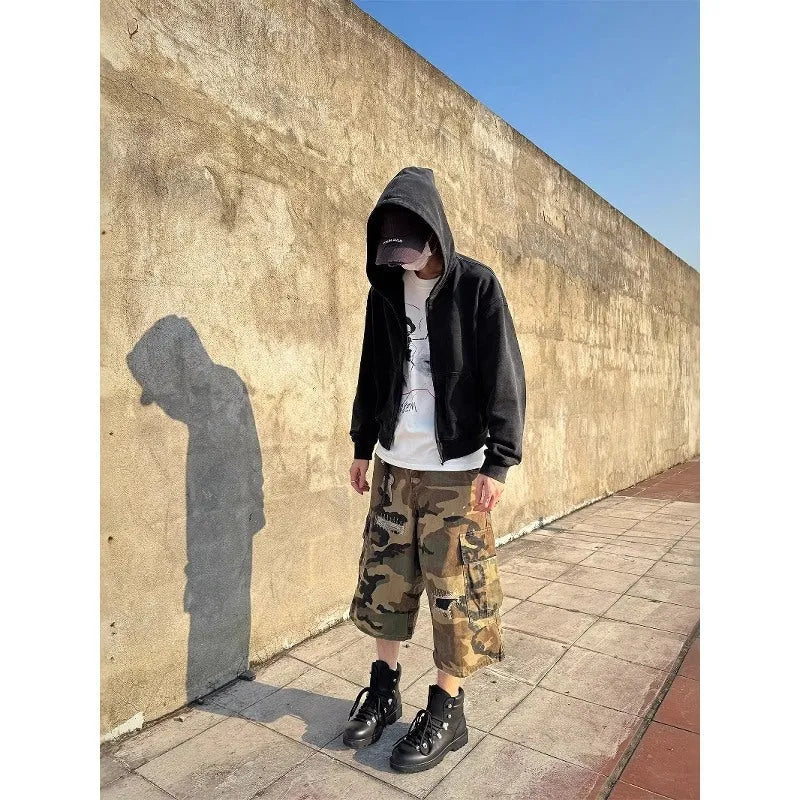 Men's camouflage coloured jeans with patchwork and ripped details, cropped length, straight loose fit.