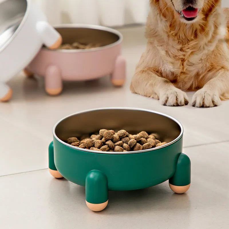 Green stainless steel pet bowl with high foot and non-slip base on a floor