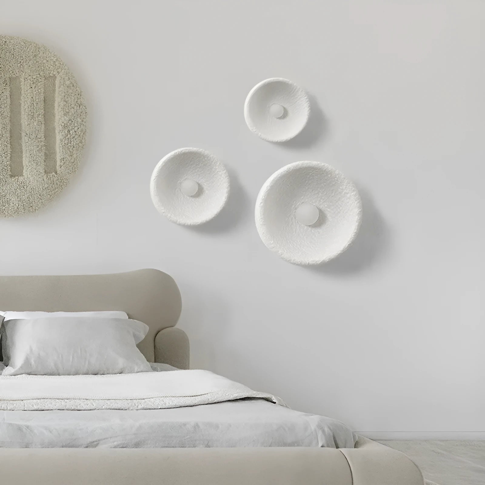 Japanese-style simple silent wall lamp with a white resin shade in three size diameters.